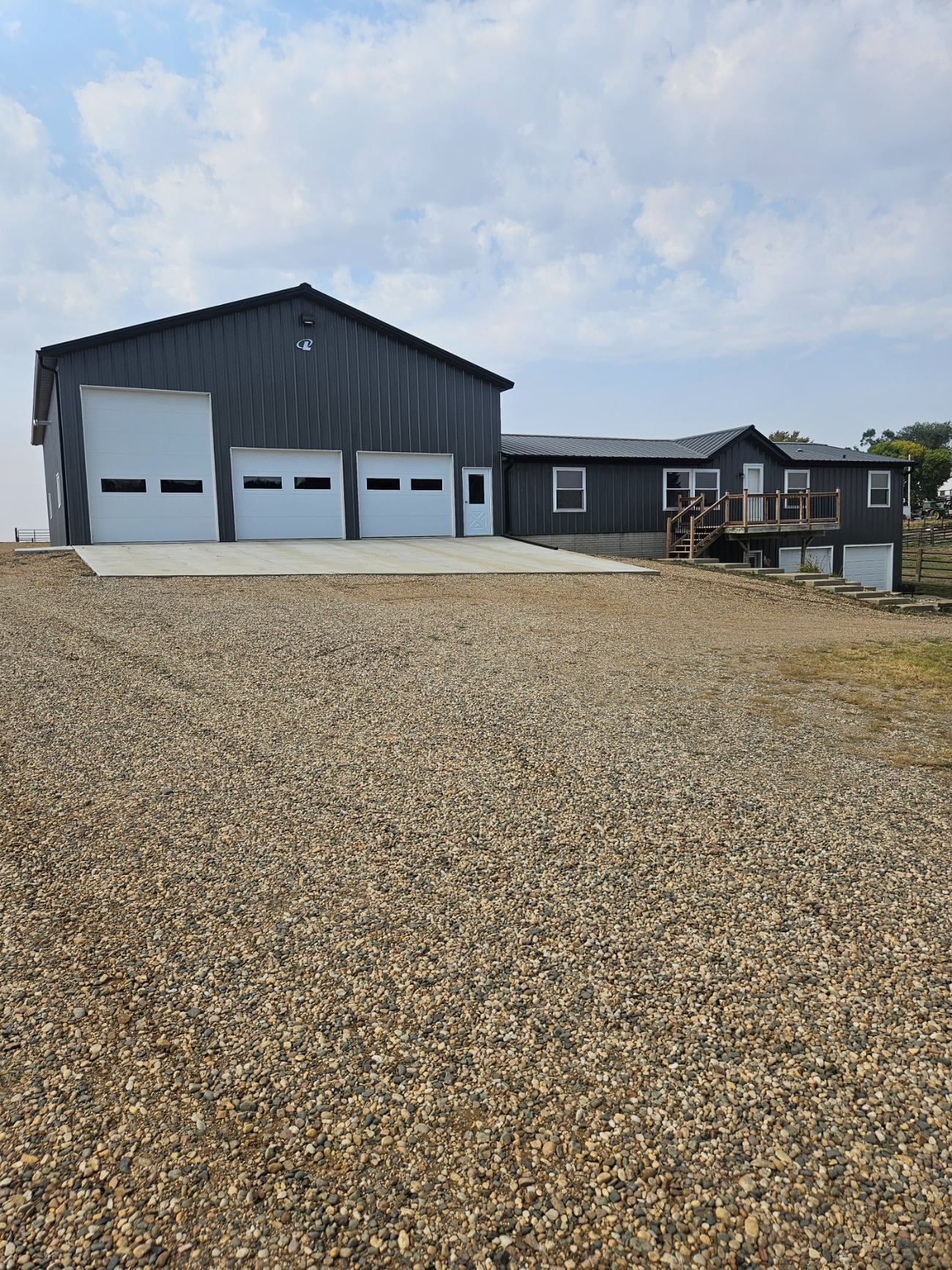 Post-frame hobby building with clean standing-seam metal appearance